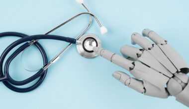 Robot hand toy finger and medical stethoscope on blue background, AI and smart technologies in medicine and diagnostic concept. (Pakin Songmor / Getty Images)