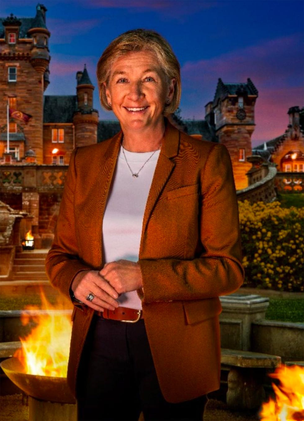 person standing in front of an ornate building with a fire pit