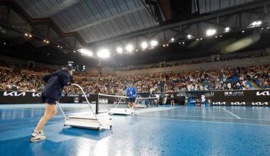 Ball kids dry a court at the Australian Open on Wednesday evening.