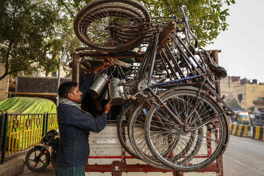 Bicycles are seen mounted on a milk vendor’s truck in Varanasi, India. Photo: AFP