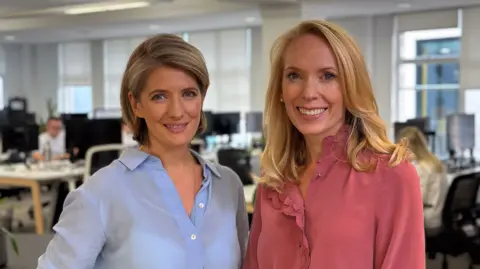 Board Intelligence Jennifer Sunberg in a blue shirt stands next to Pippa Begg in a dark pink blouse