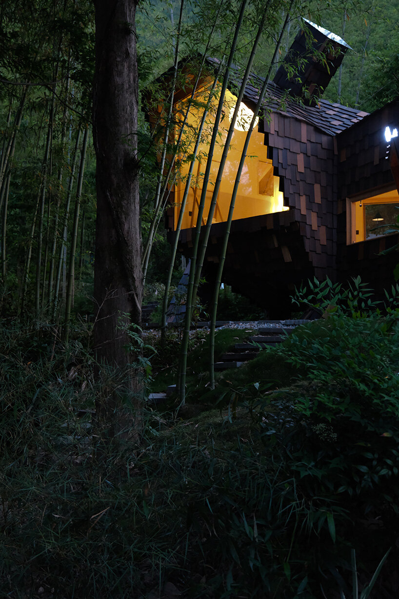 patchwork exterior of 'cat house' in china's anji forest is clad in discarded bamboo tiles