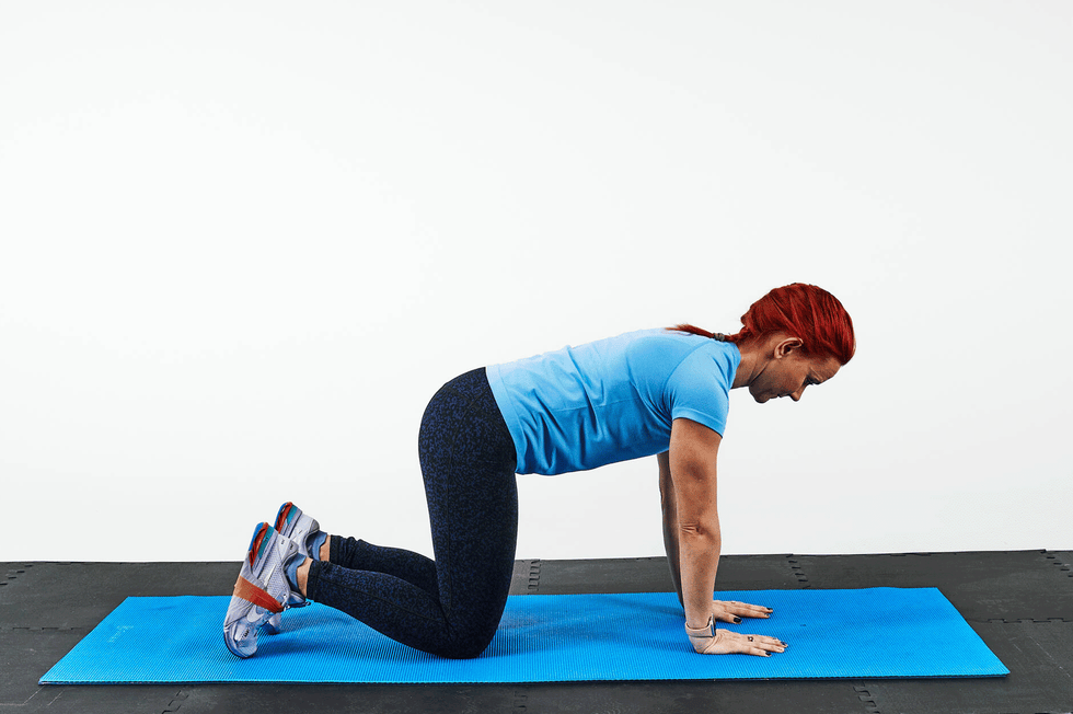 person performing an exercise on a blue mat