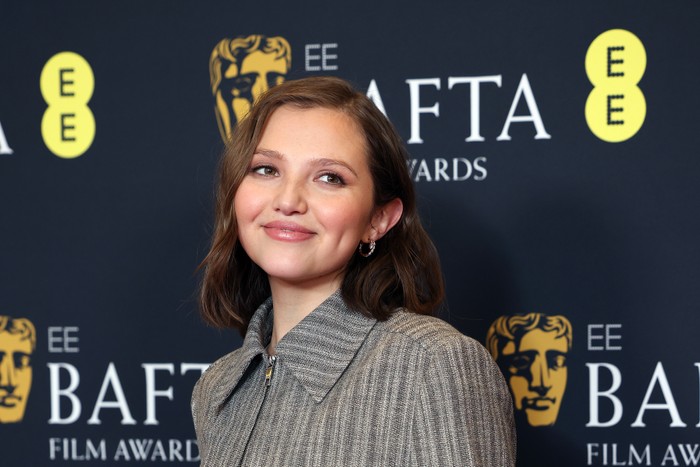 Mia McKenna-Bruce in a grey jacket at the Bafta Film Awards.