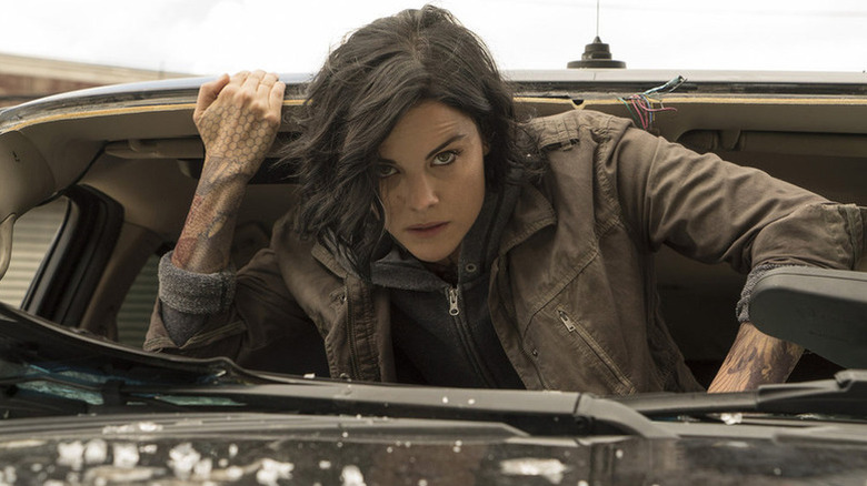 Jane Doe (Jaimie Alexander) crawls out of a car window in Blindspot