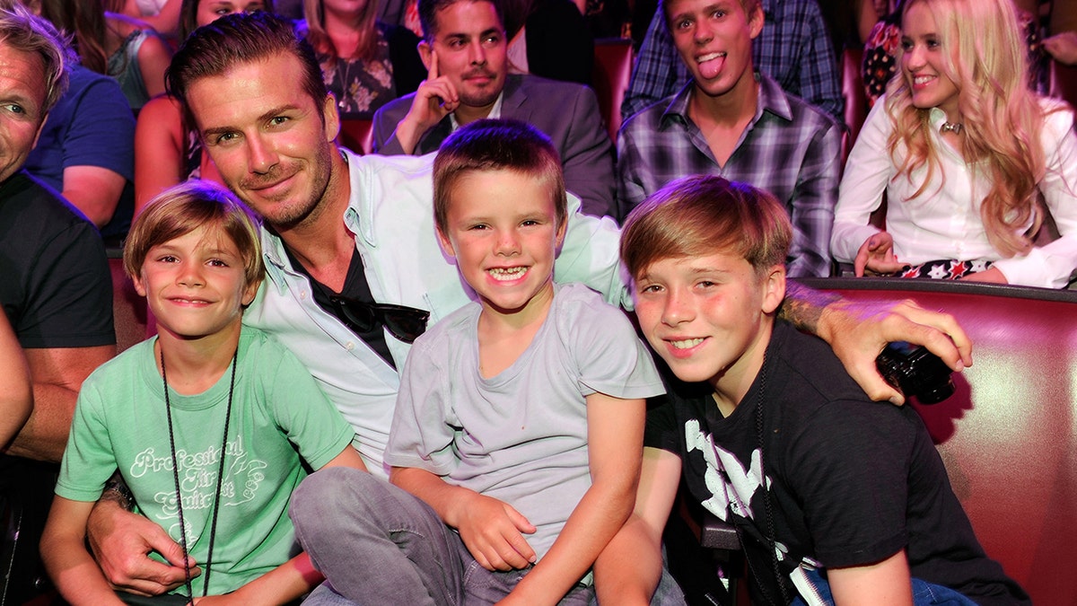 Brooklyn Beckham with his dad and siblings at the 2011 Teen Choice Awards in Los Angeles.