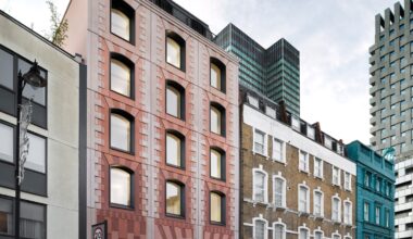 Bureau de Change enlivens apartment block with pink panels