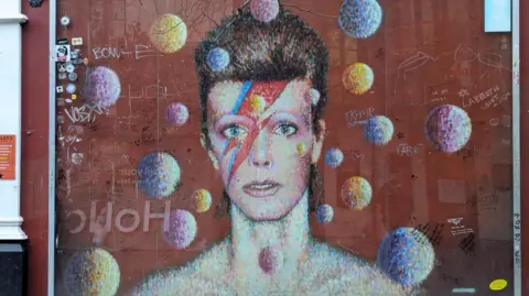 A mural on a wall in Brixton featuring David Bowie as Ziggy Stardust. 