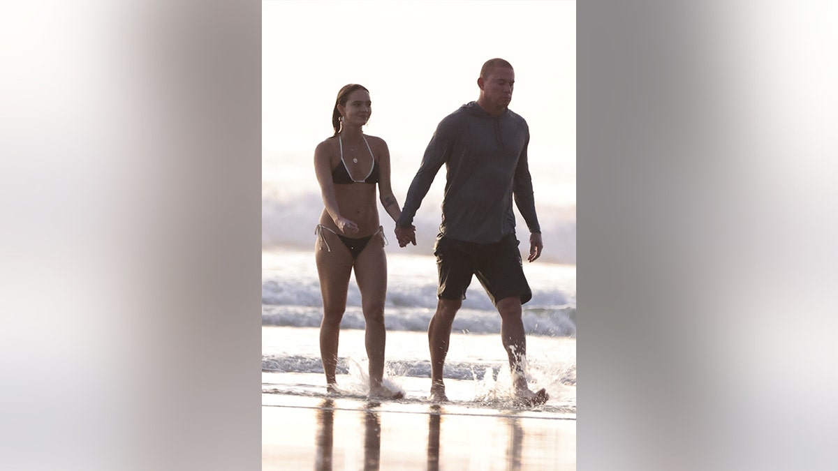 Channing Tatum and his girlfriend walked hand in hand on the shore.