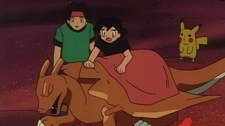 Tracy, Ash, and Pikachu taking care of an injured Charizard by a campfire in the Pokemon anime
