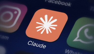 The Claude app – an orange background with a white Claude logo – on a smartphone screen.