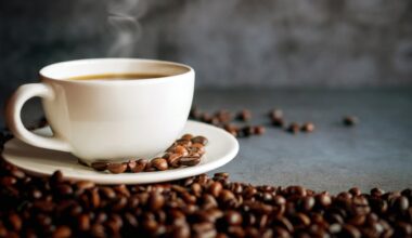 A steaming cup of coffee surrounded by coffee beans