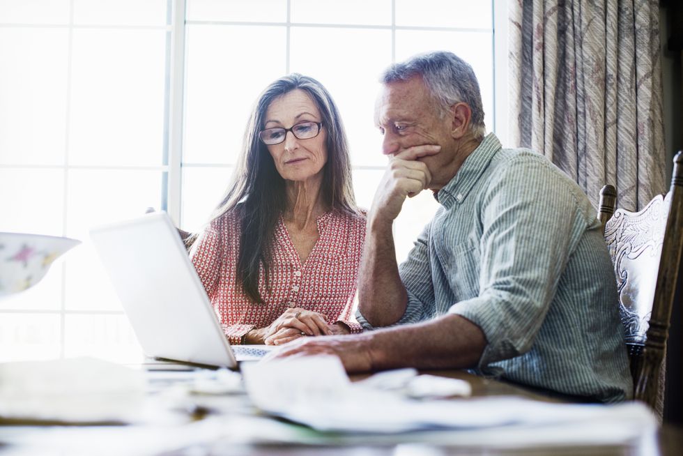 Couple look at laptop