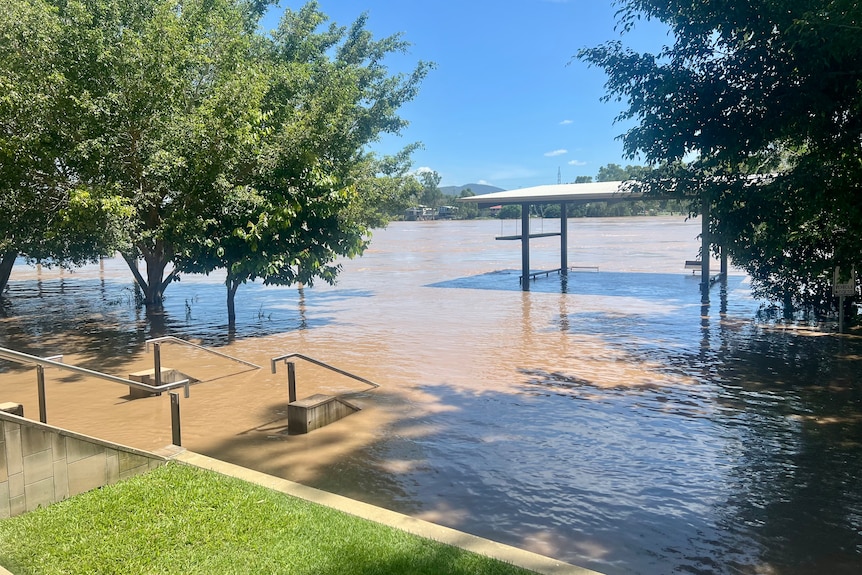 Brown water covering some stone stairs at a riverside area
