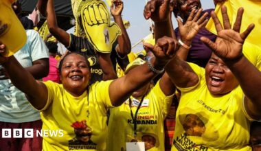 A woman sells bananas near campaign posters of Uganda's President and the leader of ruling National Resistance Movement (NRM) party, Yoweri Museveni, following the general elections in Kampala, Uganda January 17, 2026