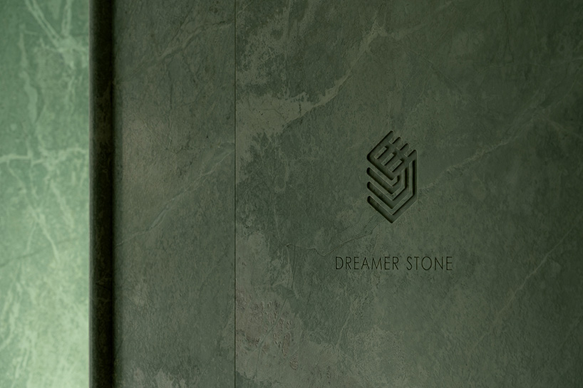 green marble clads gallery showroom’s immersive interiors in shenzhen