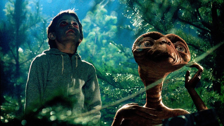 Elliott Taylor and E.T. in the forest in 