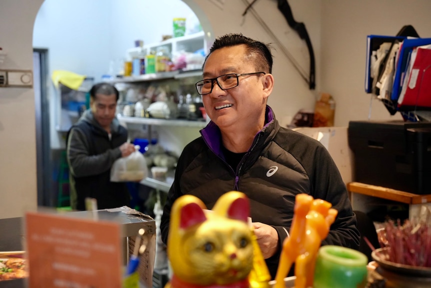 Vinh Ky restaurant owner Christopher Nguyen smiles from behind the counter