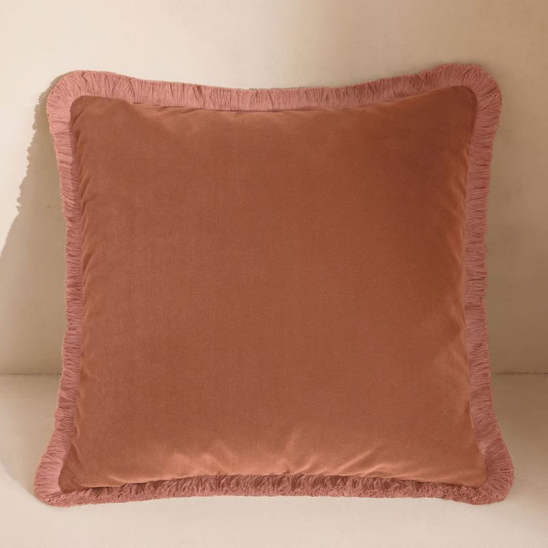 pink cushion with fringe edge