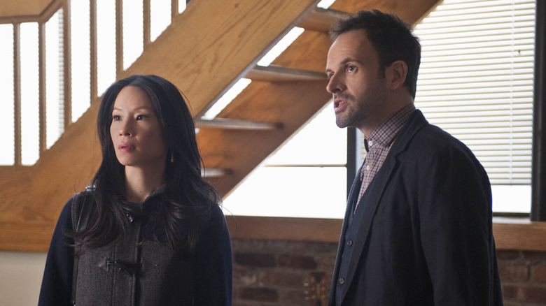 Joan Watson and Sherlock Holmes look shocked in Elementary