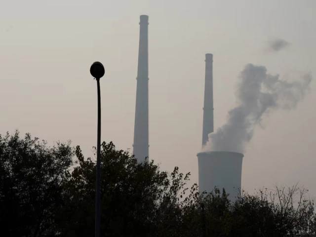 a cooling tower and chimneys are seen at a thermal power plant in beijing china november 3 2018 reuters