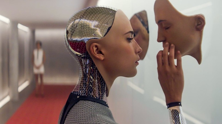Ava looking at a robot's face in "Ex Machina"