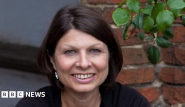 Prime Minister Mark Carney, wearing a black suit jacket, and a white button-up shirt leans his chin on his hands. He has short grey and black hair and is looking away from the camera.