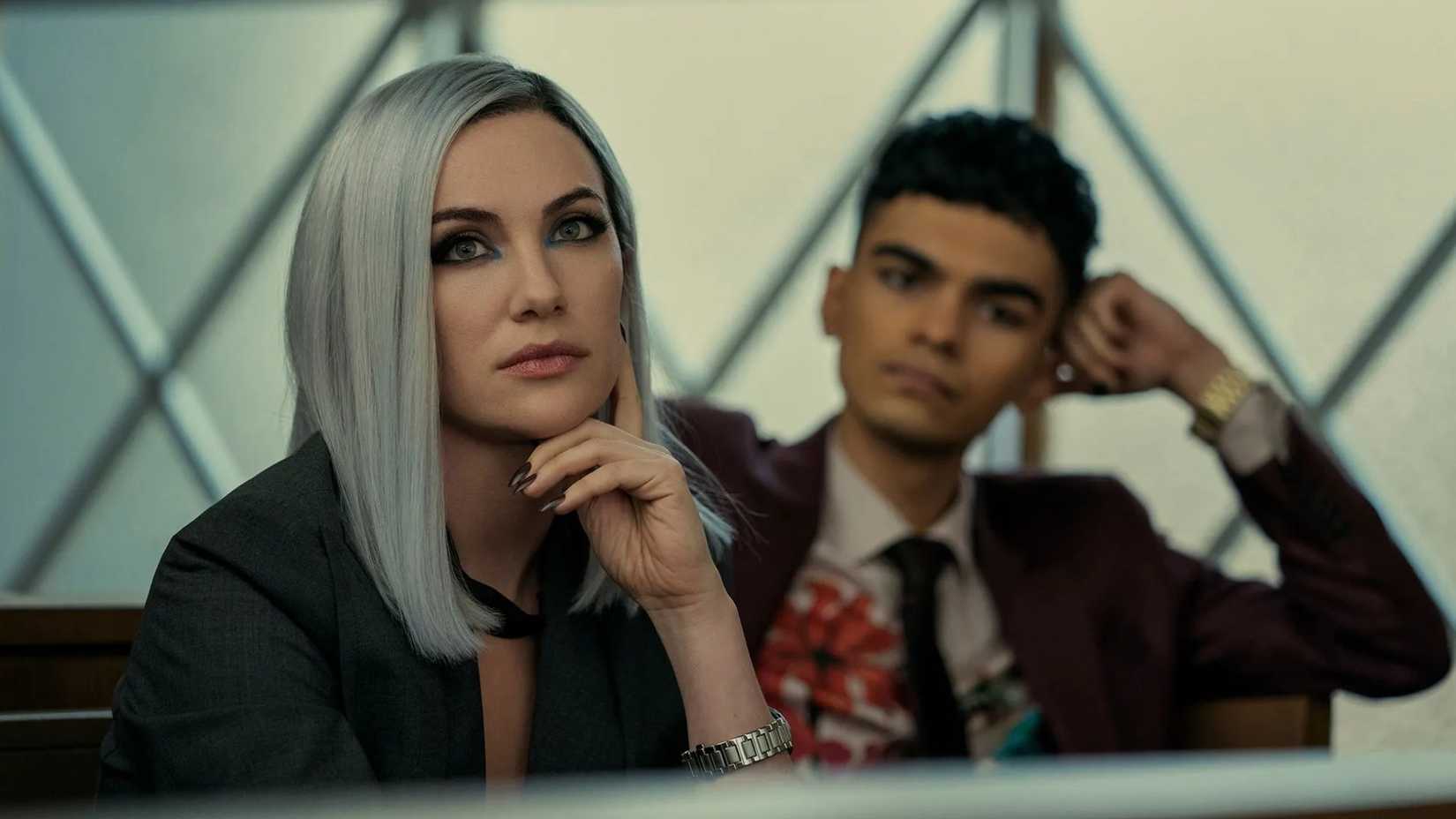 A woman with silver hair looking bored in Netflix's The Fall of The House of Usher.