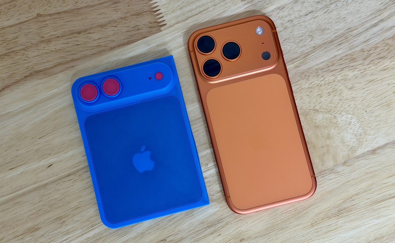 Two phone cases on a wooden surface: a blue one with circular cutouts and a red one with square cutouts for camera lenses.
