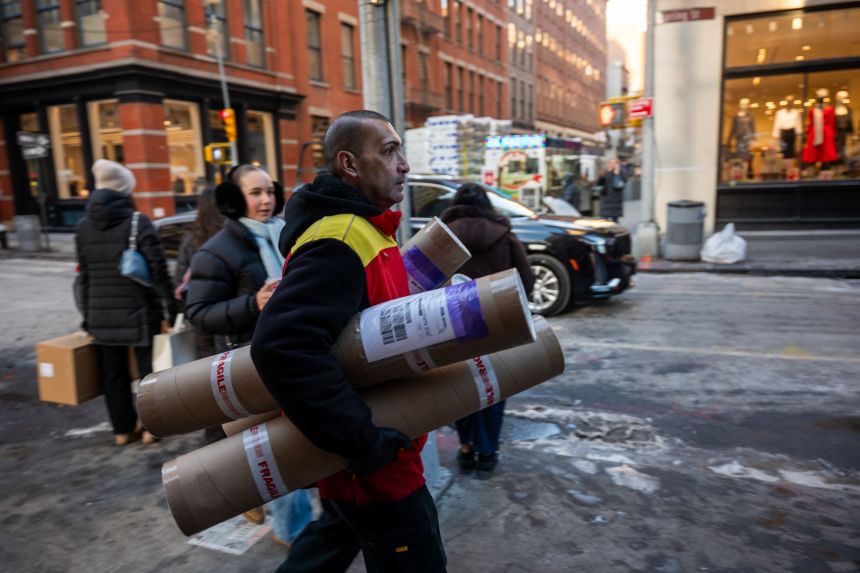 A man makes deliveries in Manhattan in New York City, on December 16, 2025.