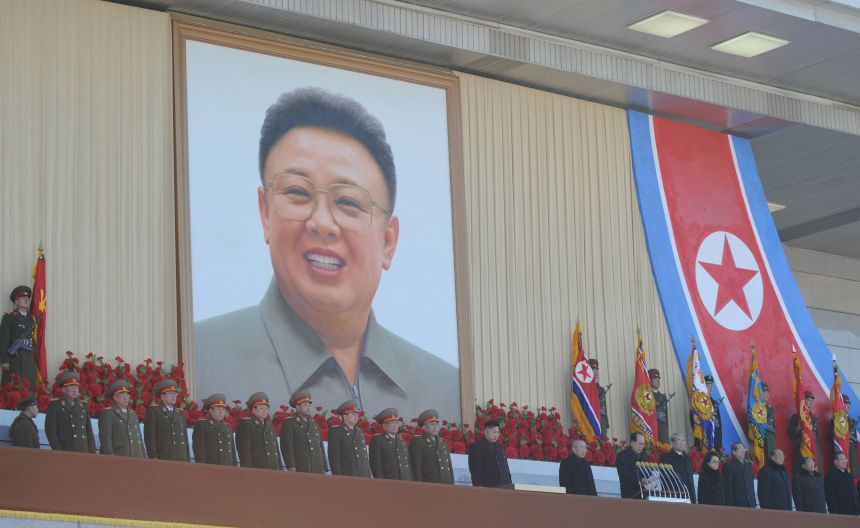 North Korea's leader Kim Jong Un (center) and senior military officers view a military parade in Pyongyang on February 16, 2012. A portrait of Kim Jong Il hangs above.