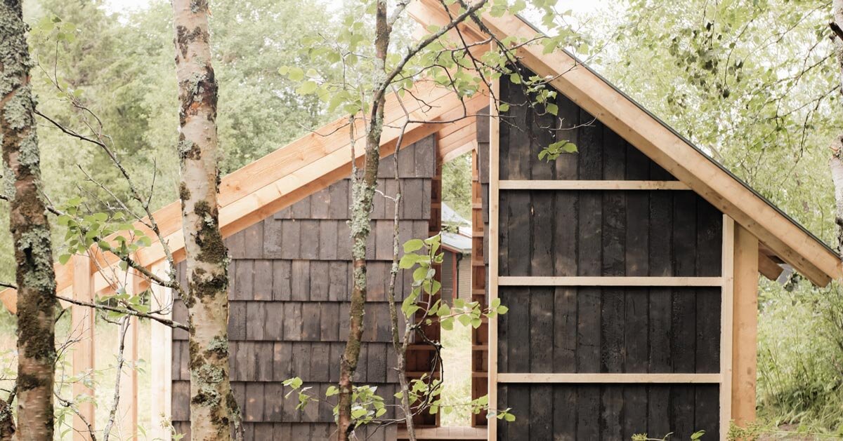 fireplace shelter made from reclaimed materials stands in northern norway