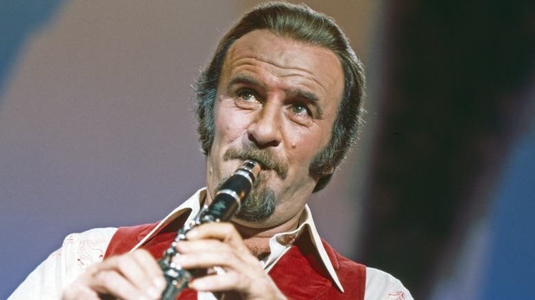 Mr. Acker Bilk in red vest playing violin