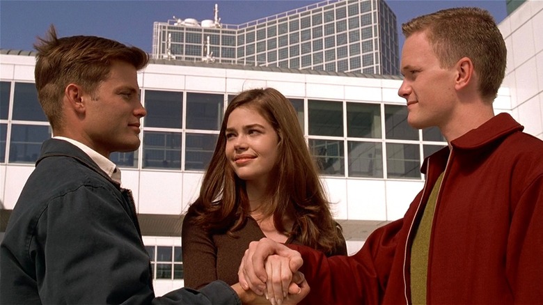 Johnny, Carmen, and Carl putting their hands in a stack in 