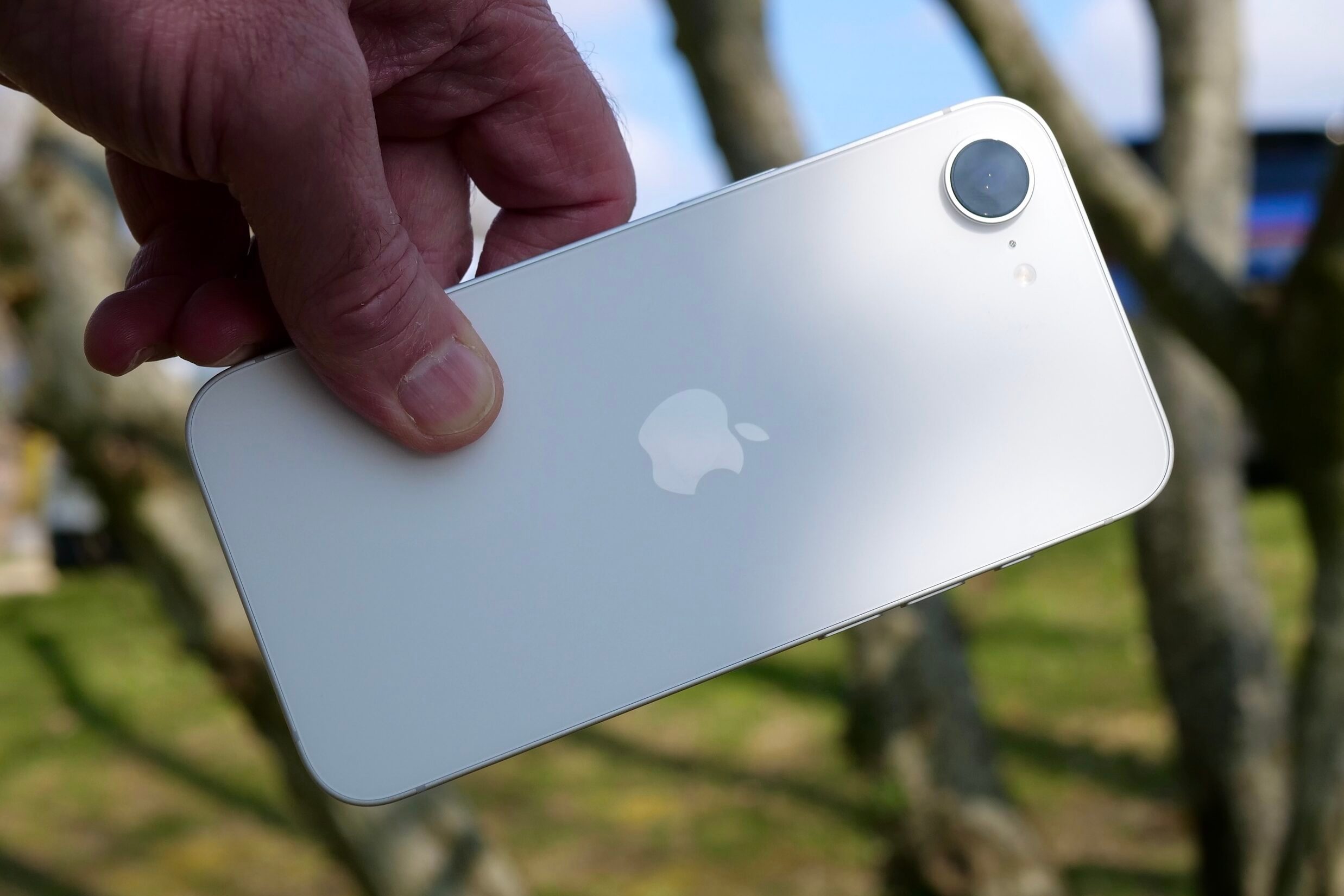 A person holding the Apple iPhone 16e.