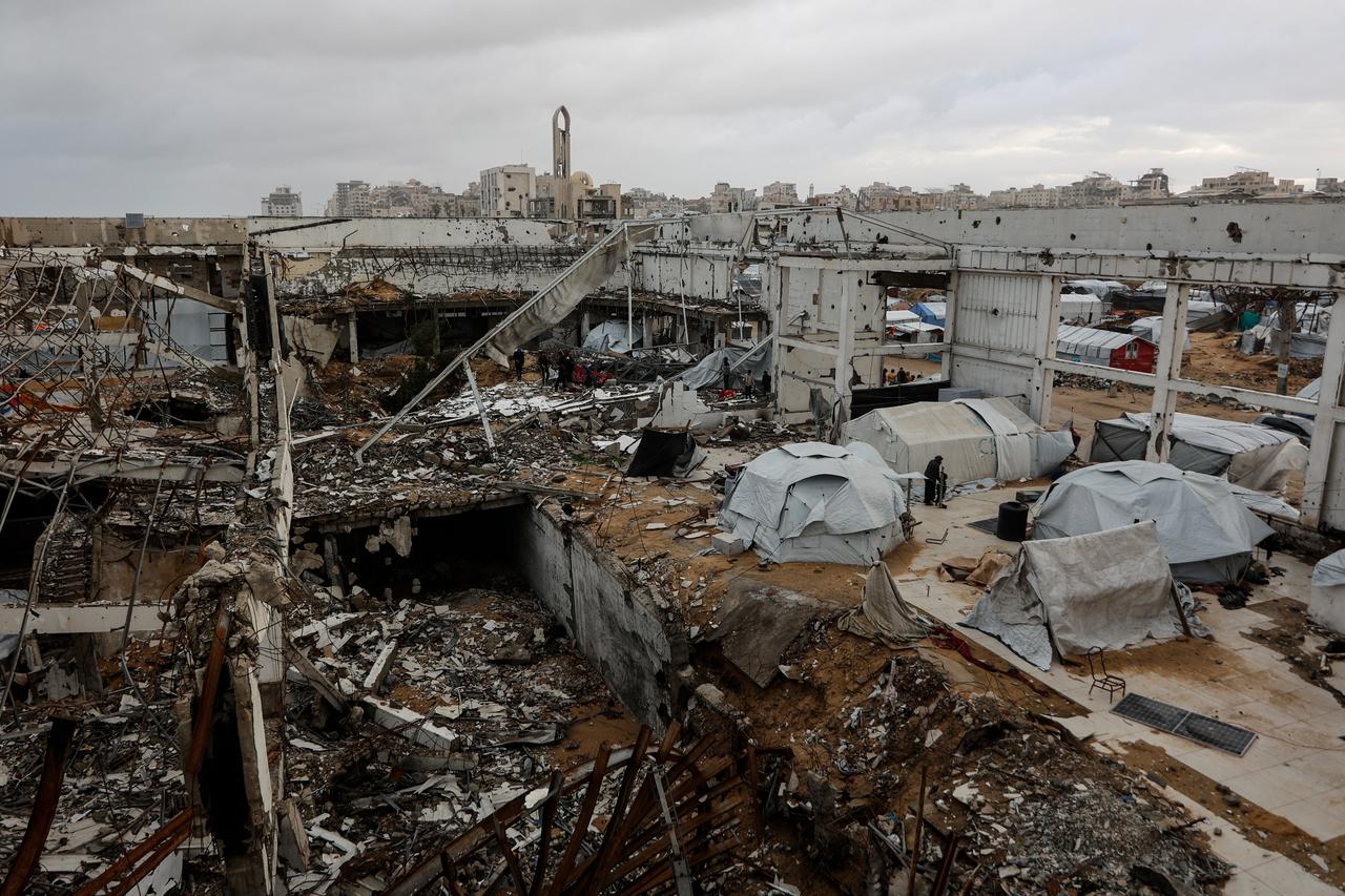 A photograph shows makeshift shelters inside a war-damaged building, parts of which collapsed on a windy winter day in Gaza City, January 13, 2026. (AFP Photo)