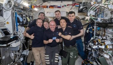 iss073e1198029 (Nov. 27, 2025) --- The seven-member Expedition 73 crew gathers together for a portrait inside the International Space Station's Kibo laboratory module celebrating NASA astronaut Mike Fincke's (center) 500 cumulative days in space over four missions since 2004. In the front from left are, Roscosmos cosmonaut Sergey Ryzhikov, NASA astronaut Zena Cardman, Mike Fincke, and NASA astronaut Jonny Kim. In the back are, JAXA (Japan Aerospace Exploration Agency) astronaut Kimiya Yui and Roscosmos cosm