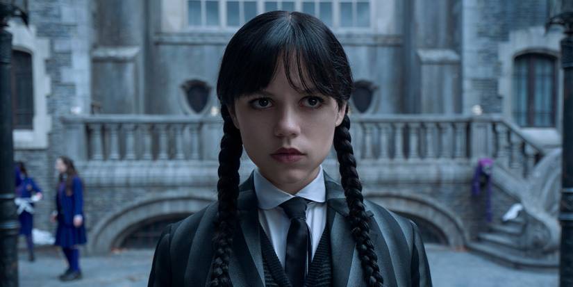 Jenna Ortega as Wednesday Addams standing in the Nevermore Academy courtyard in Wednesday.