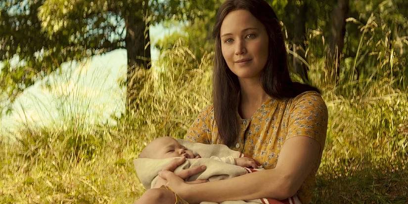 Jennifer Lawrence as Katniss in The Hunger Games holding her baby