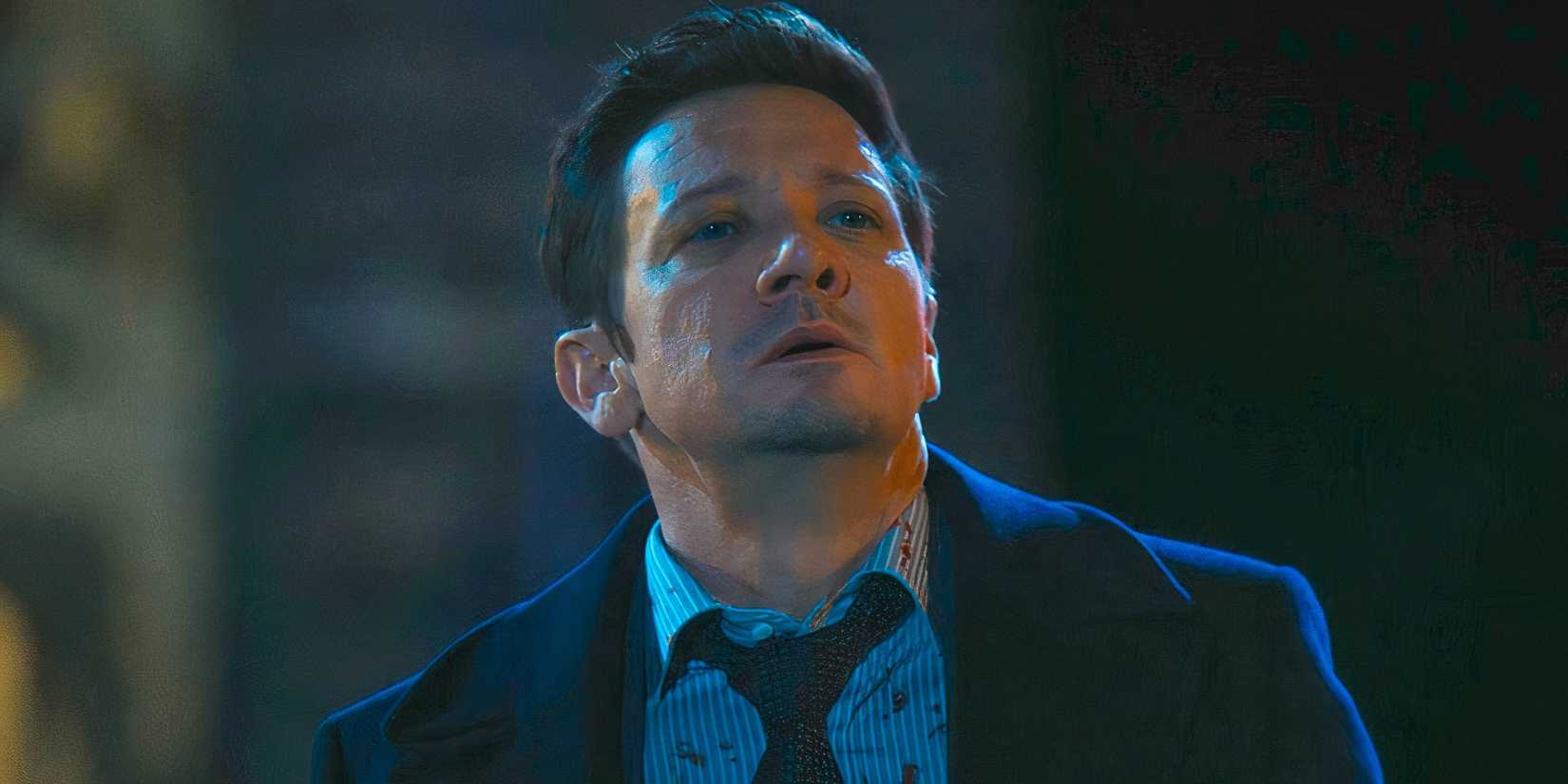 Jeremy Renner as Mike with his head tilted back and blood on his shirt in Mayor of Kingstown season 3