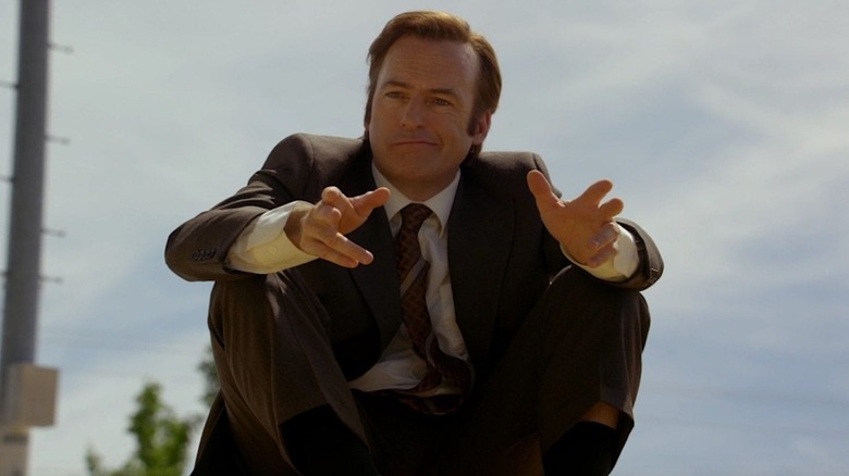 Bob Odenkirk as Jimmy McGill sitting outside gesturing with his hands in Better Call Saul