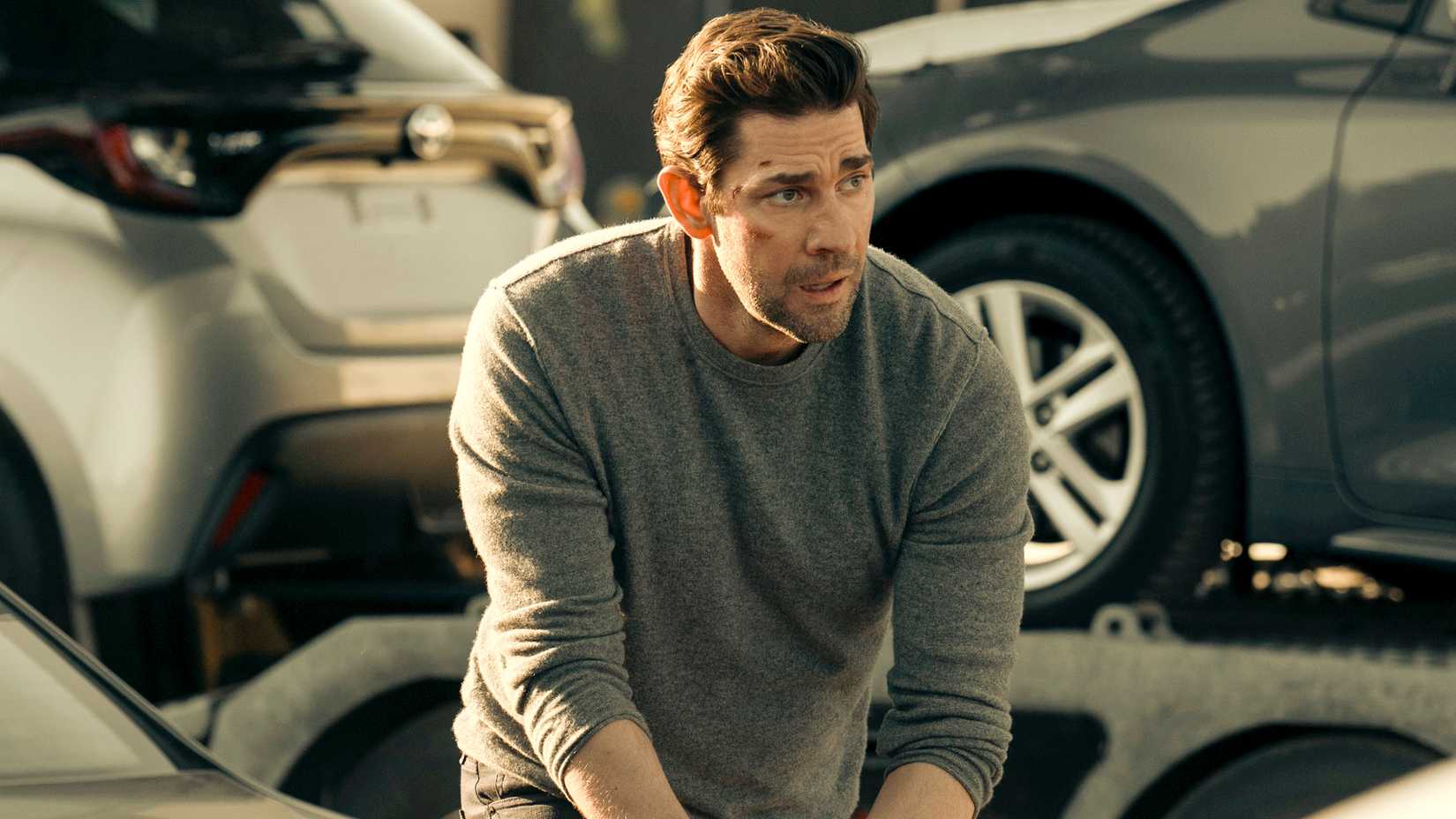 John Krasinski as Jack Ryan moving through cars