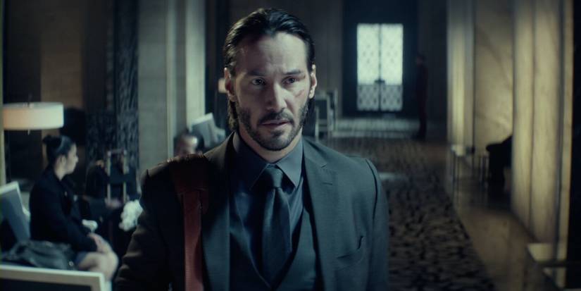 John Wick (Keanu Reeves) checks into the Continental Hotel.