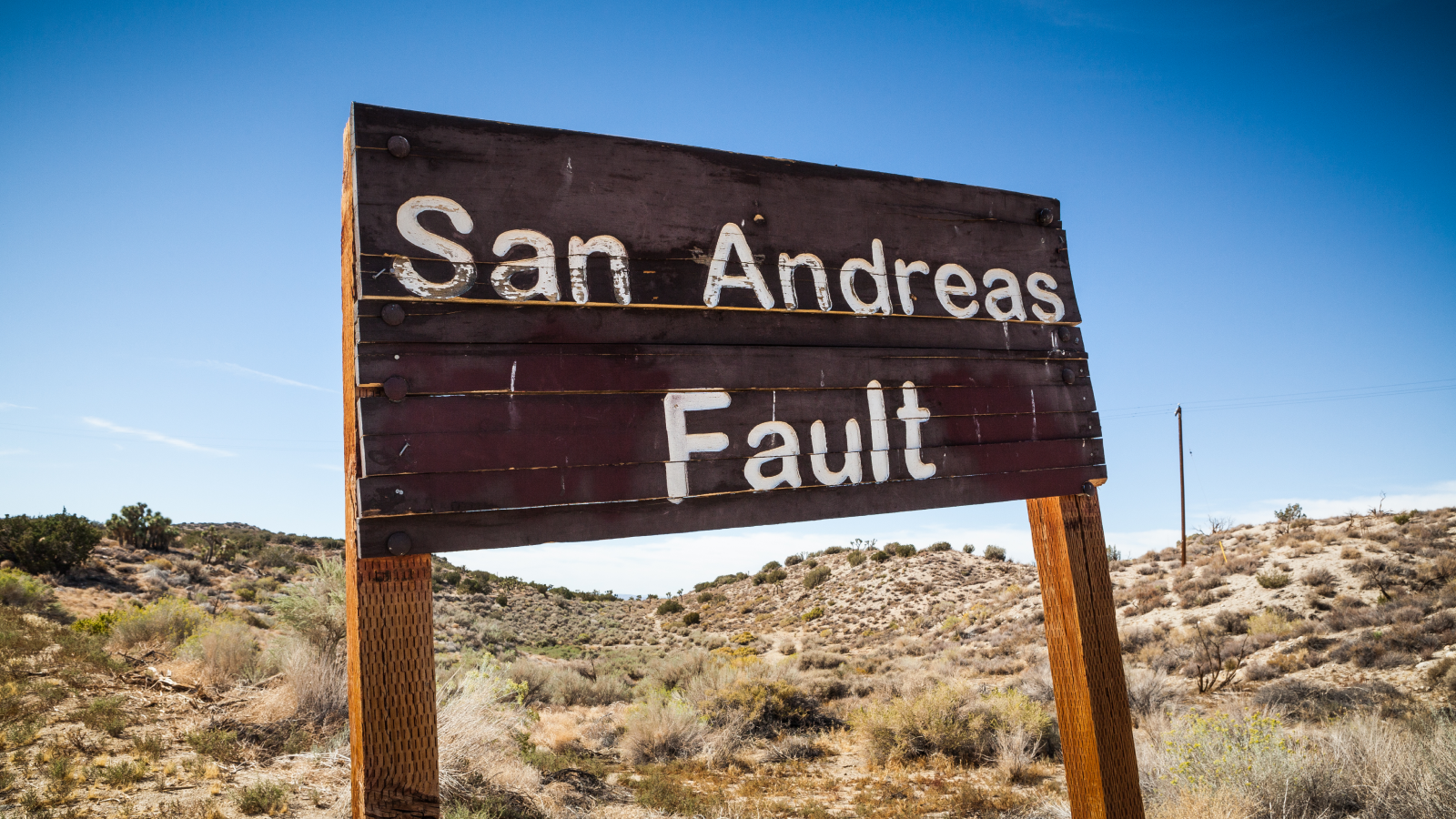 A sign posted where the San Andreas Fault intersects with Pallet Creek Road in Pearblossom California, a small town in Los Angeles County.