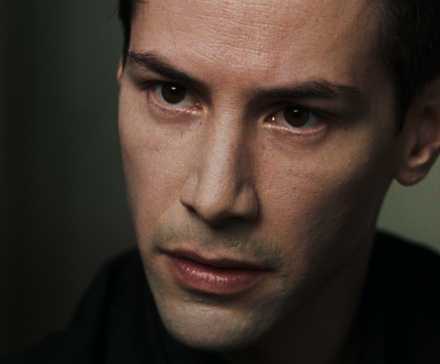 Keanu Reeves in The Matrix looking forward
