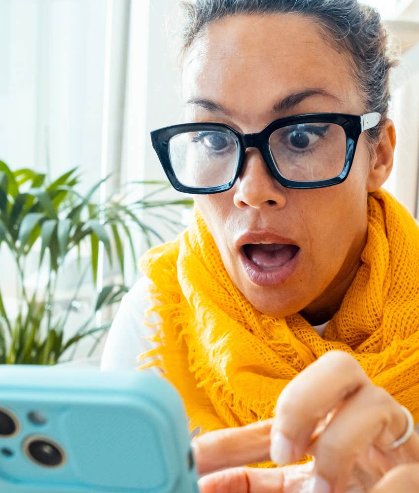 Shocked person with mobile phone showing missed meaning in song