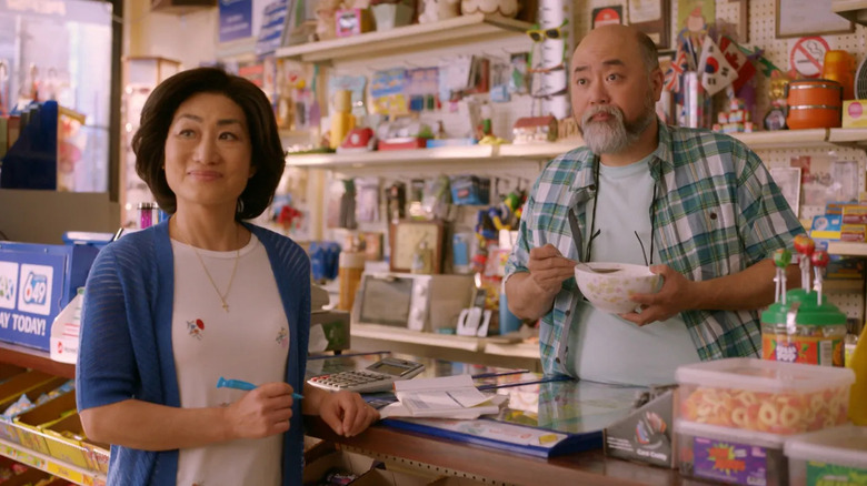 Mrs. Kim (Jean Yoon) and Mr. Kim (Paul Sun-Hyung Lee) speak to a customer in Kim's Convenience
