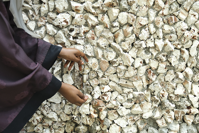 perforated corrugated panels regulate light and ventilation at library in tanzania