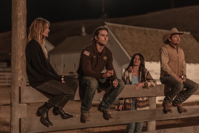 Early Release Images Beau Garrett as Abigail Reese, Ben Schnetzer as Van Davis, Danielle Vasinova as Kestrel Harris, Kevin Zegers as Cade Harris in The Madison sitting on a fence in the dark and chatting.