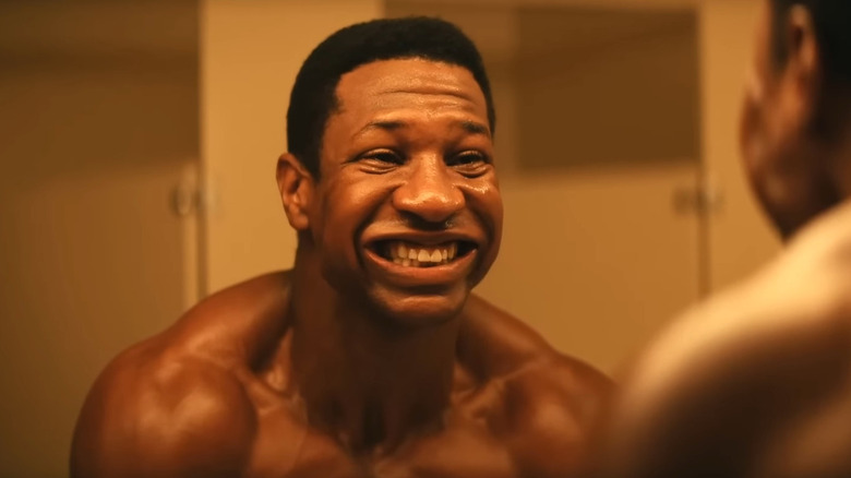 Killian flexing and smiling maniacally in mirror